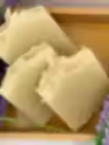 Lavender square soap bars, with lavender leaf beside the bars.