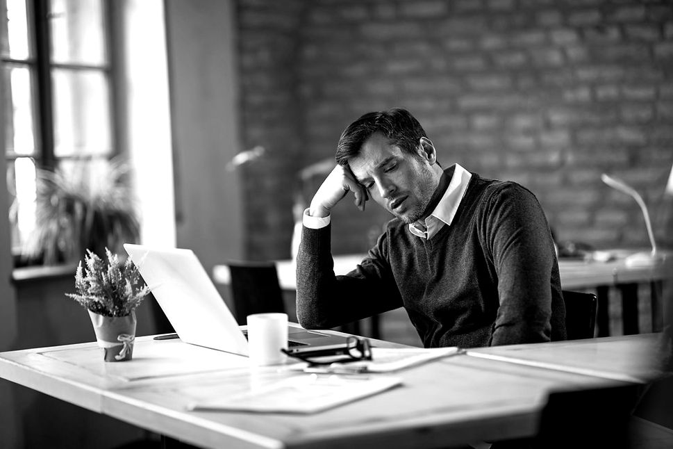 overworked-businessman-sitting-his-desk-thinking-something-office_edited.jpg