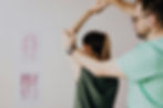 Physical Therapist raising the arm of a female patient