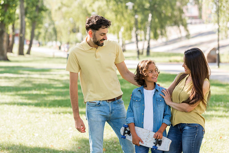 boy-with-skateboard-posing-with-parents-park.jpg