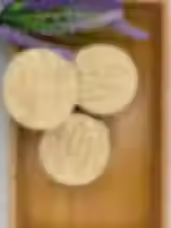 Lavender square soap bars, with lavender leaf beside the bars.