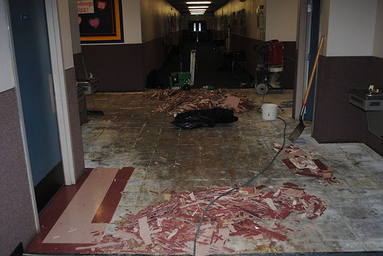 VCT tile being removed in a hallway.
