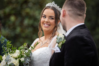 The bride looking happily at her groom
