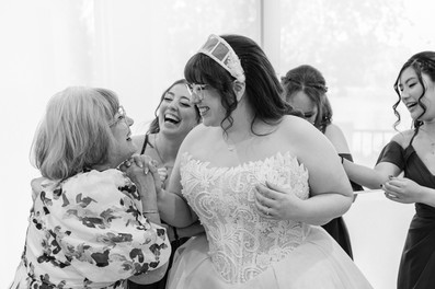 Bride sharing emotional moment with bridesmaids before ceremony