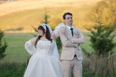 Bride and groom smiling naturally during sunset portrait session