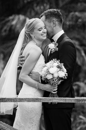 Bride and groom on bridge