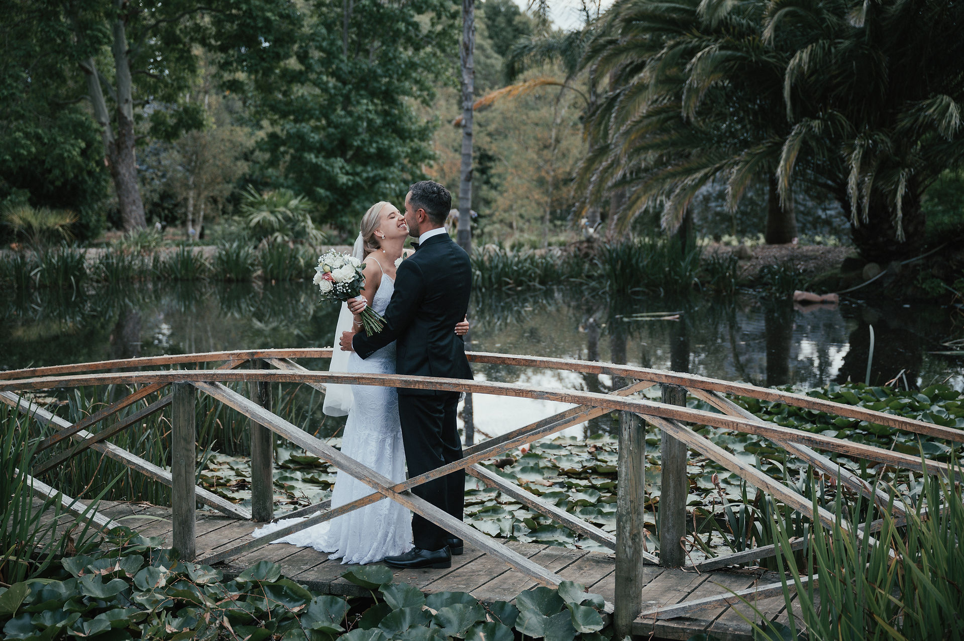Bride and groom on bridge