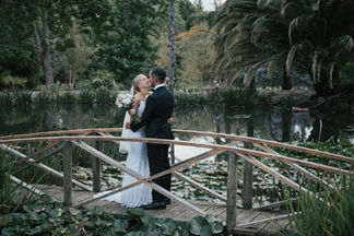 Bride and groom on bridge