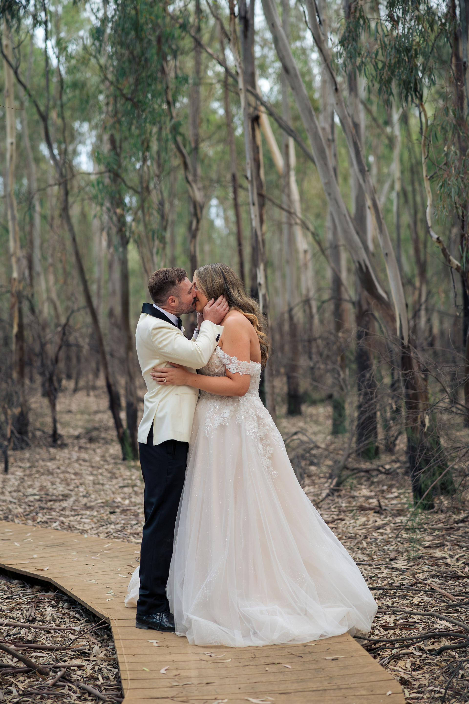 Bride holding her bouquet while embracing her groom.
