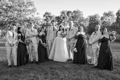 Bridal party laughing together during relaxed sunset photo session