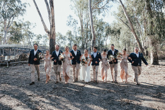 bridal party walking together arm in arm