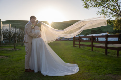 Newlyweds sharing a quiet moment during sunset at DV Cider