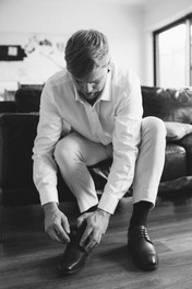 Groom tying his shoes