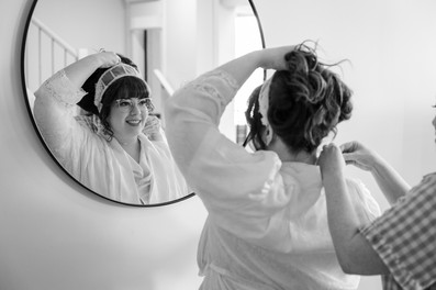 Natural wedding photo of bride getting ready with her bridesmaids