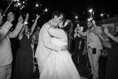 Bride and groom sharing a kiss during sparkler exit