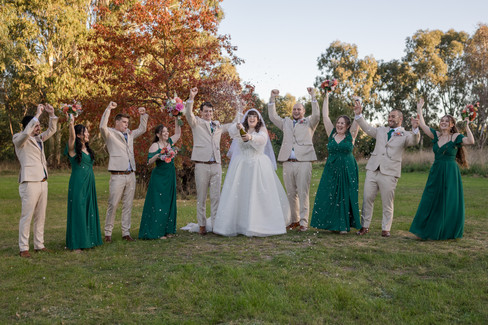 Bridal party gathered together in warm sunset light at DV Cider