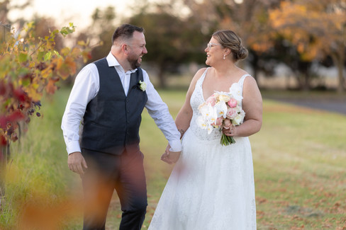 Bride and groom sharing a quiet moment amongst vineyard rows