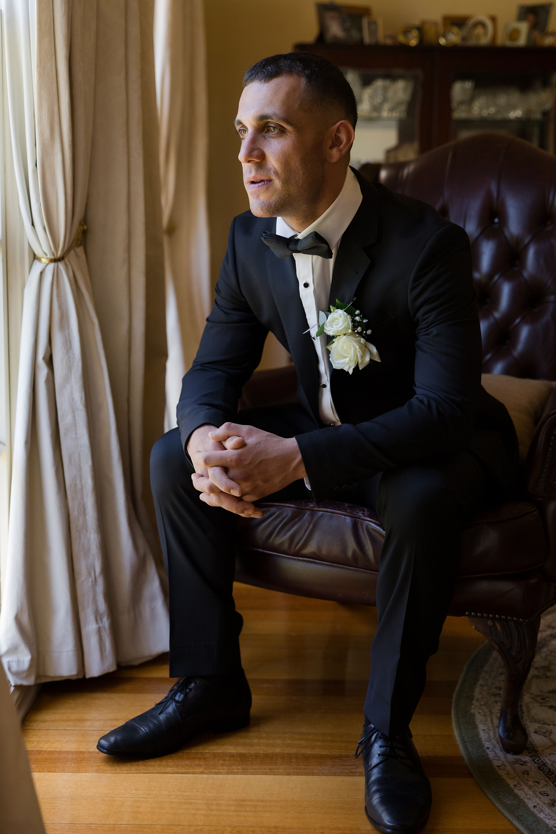 Groom portrait while finishing final touches before the ceremony