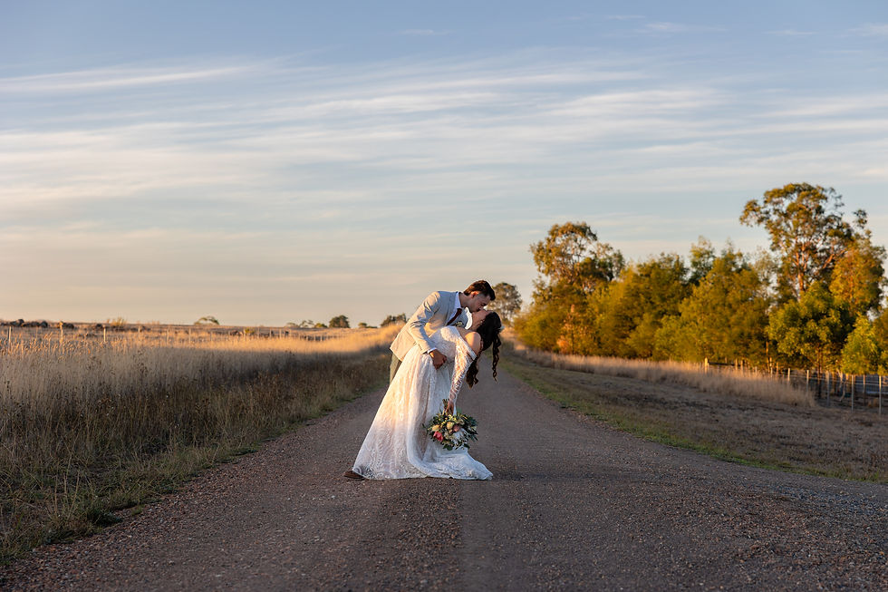 Eye-level view of a wedding photographer capturing a couple in at sunset