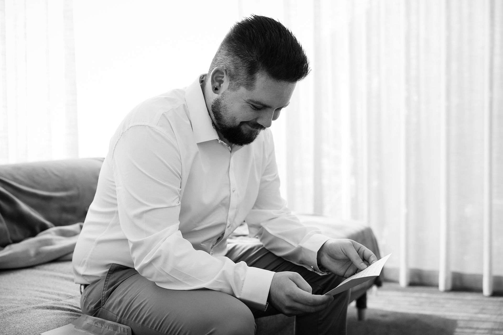 groom reading a letter from his bride