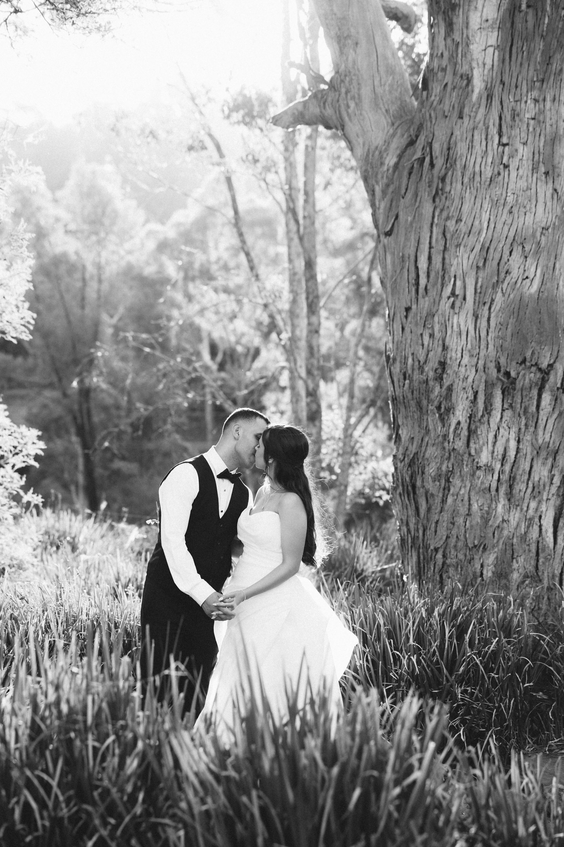 Bride and groom standing together during warm sunset light at Potters Receptions Warrandyte