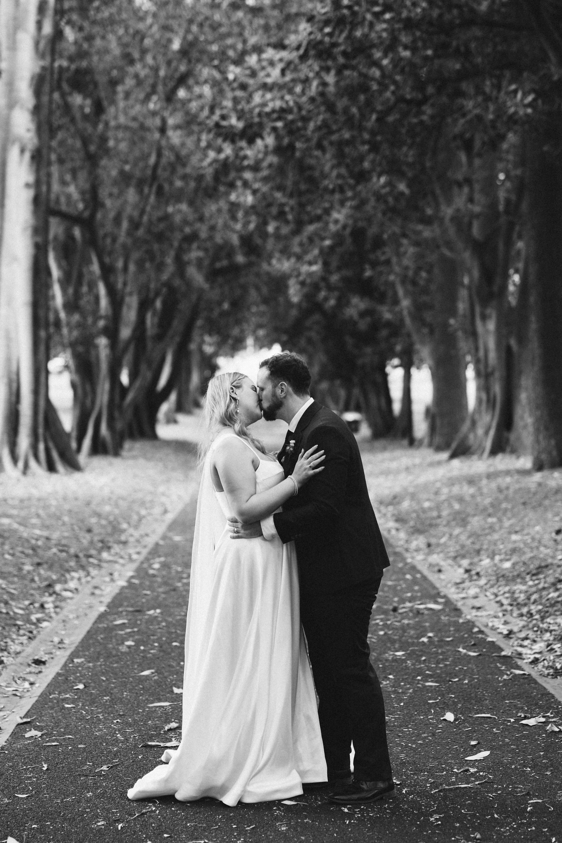 Wedding couple framed by greenery Treasury Gardens Melbourne