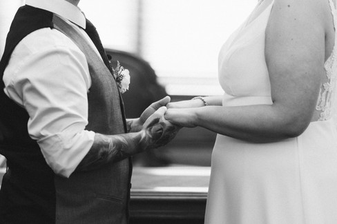 Bride and groom exchanging vows inside the elegant ceremony room at the Victorian Marriage Registry, captured by a Melbourne Wedding Photographer with soft natural light and intimate city wedding styling.