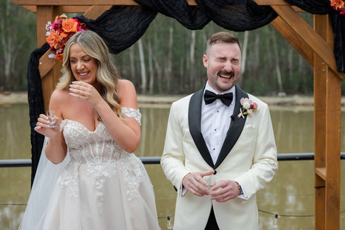 Emotional ceremony moment between bride and groom.