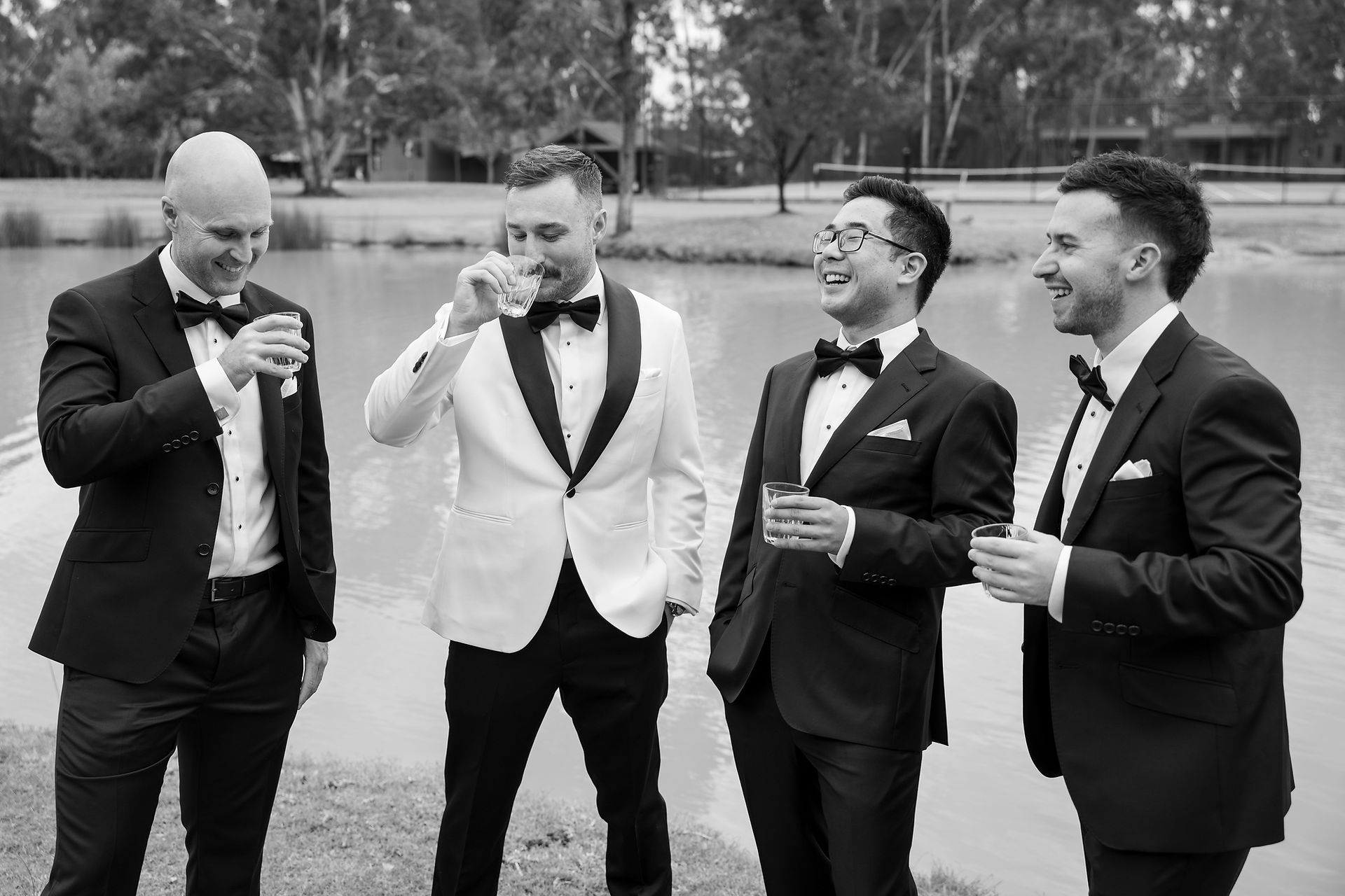 Groom and groomsmen sharing a candid moment outside the accommodation before the ceremony