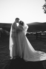 Bride and groom silhouetted against golden sunset at DV Cider