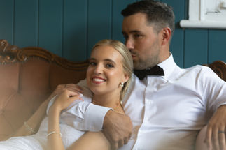 groom kissing bride on head