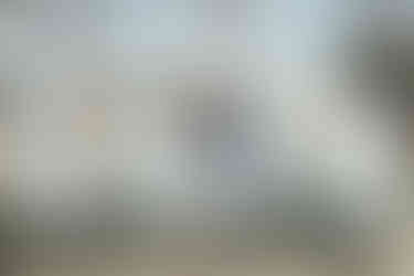 bride and groom kissing in front of large love letters