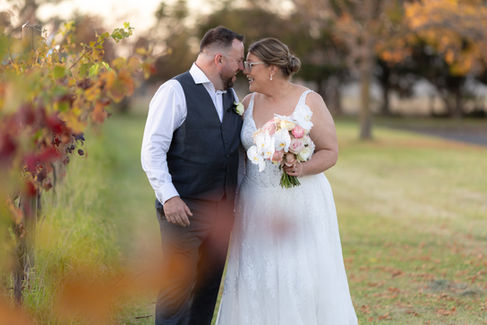 Newlyweds embracing beneath golden evening light in Melbourne