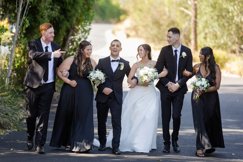 Bride and groom with bridesmaids and groomsmen during bridal party portraits at Potters Receptions