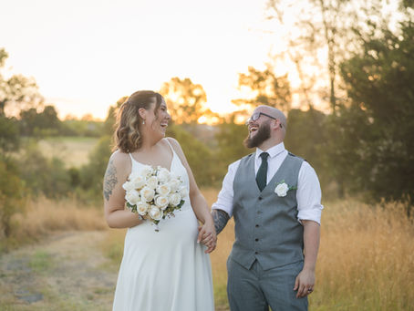 Couple walking across golf course in soft sunset light at Craigieburn Sporting Club.