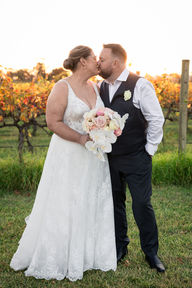 Bride and groom sharing a kiss under warm sunset light