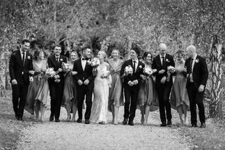 bridal party walking arm in arm