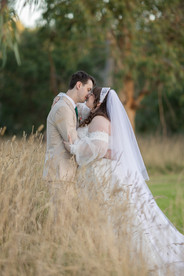 Bridal party portrait with dramatic sunset lighting in Macedon Ranges
