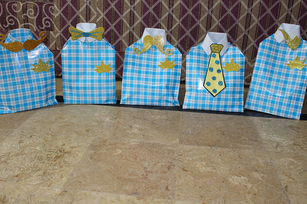 Return gifts having magic cups, packed in shirts shape