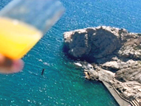 enjoyinh a drink while viewing the rocky coastline 