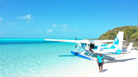 Seaplane at a Bahamian beach with turquoise water