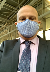 Paul in a suit wearing a facemask