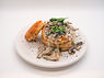 A plate of round phyllo stuffed with mushroom sauce and topped with greens