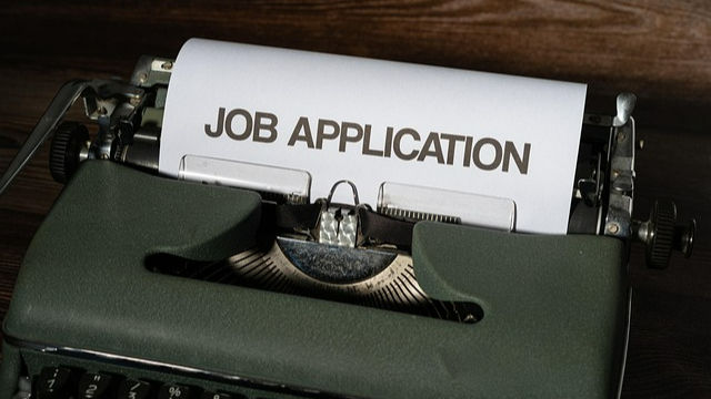 a typewriter with a job application typed out