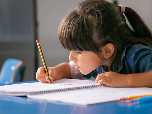 a girl doing home work on a table
