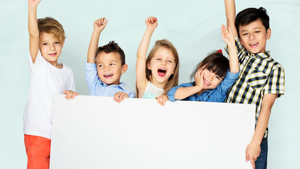 5 kids cheering in a line with one of their hands up 