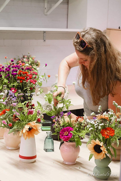 Jenny arranging flowers for an indoor event.