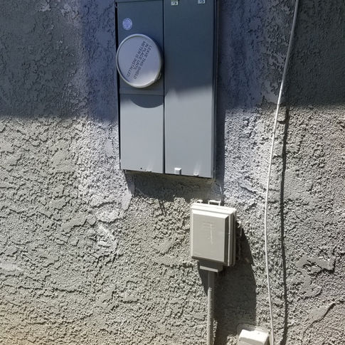 An electrical box on the side of a house