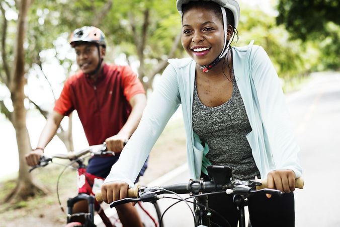 cyclist-couple-riding-together-in-a-park-royalty-free-image-1656092621.jpg
