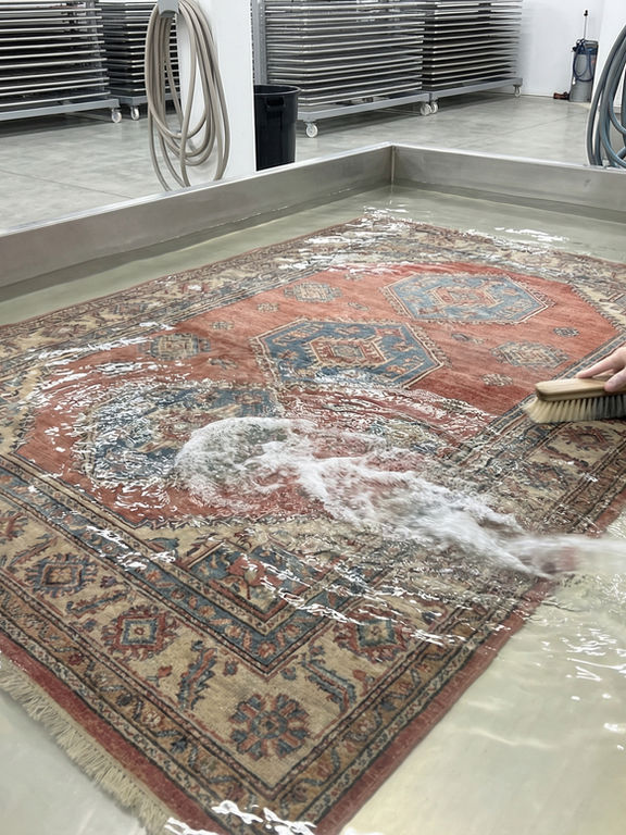 Professional immersion cleaning of oriental rug in specialized facility